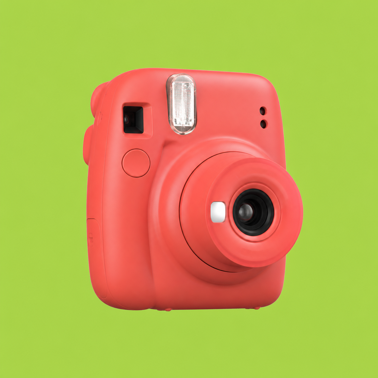 Coral instant camera on a lime-green background.